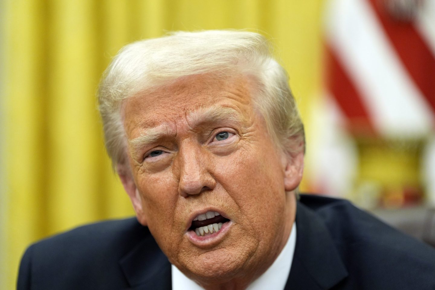 President Donald Trump speaks with reporters as he signs executive orders in the Oval Office at the White House, on Feb. 10, 2025, in Washington.