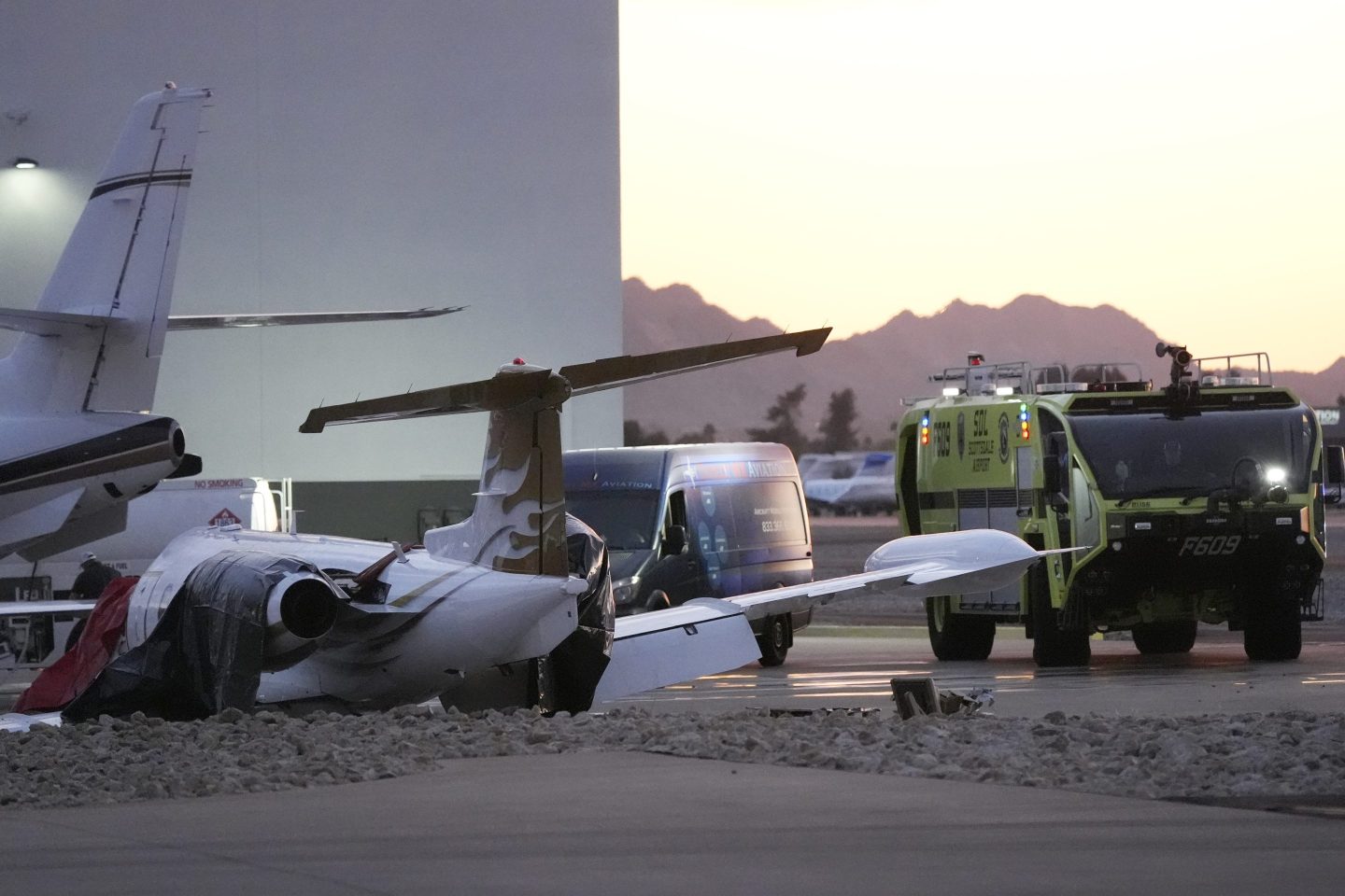 A private jet that crashed into a business jet looks crumpled on the tarmac