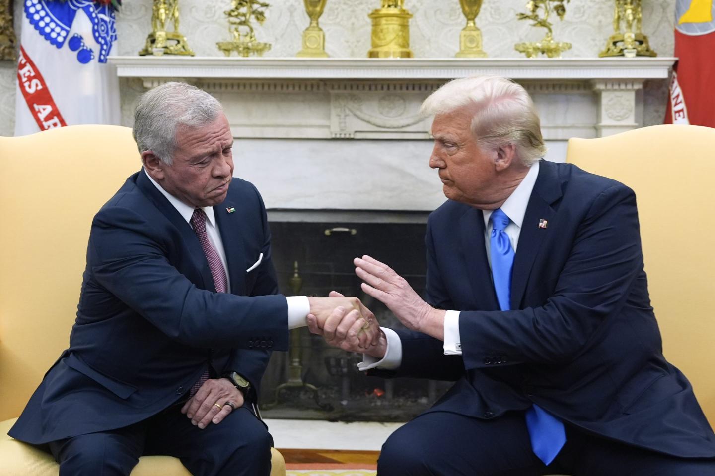 Trump sits in the Oval Office with Jordan's King Abdullah II while patting his hand