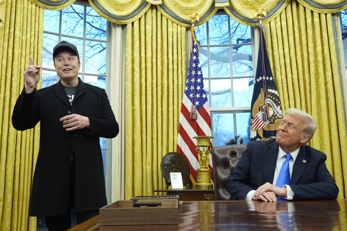 President Donald Trump listens as Elon Musk speaks in the Oval Office at the White House, on Feb. 11, 2025, in Washington.
