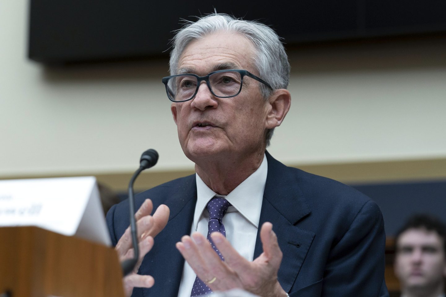 Fed Chair Jerome Powell speaks in front of a microphone