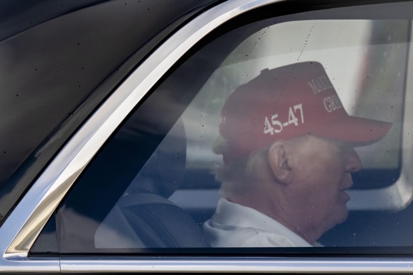 A side profile of Trump as he sits in his motorcade