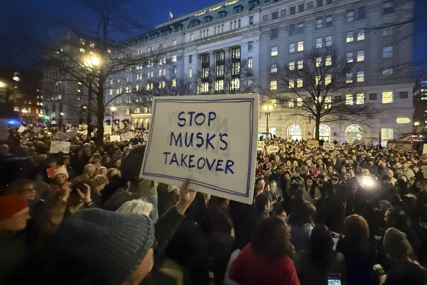 People protest during a rally outside the Treasury Department in Washington, Feb. 4, 2025.