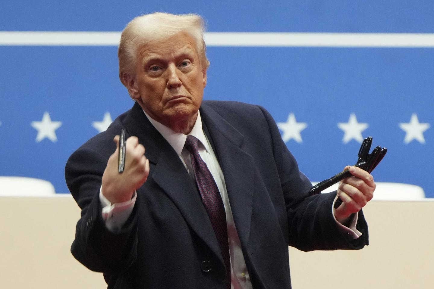 Donald Trump throwing writing pens into a crowd