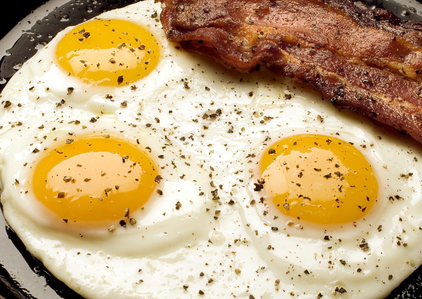 A close-up photo of eggs and bacon.