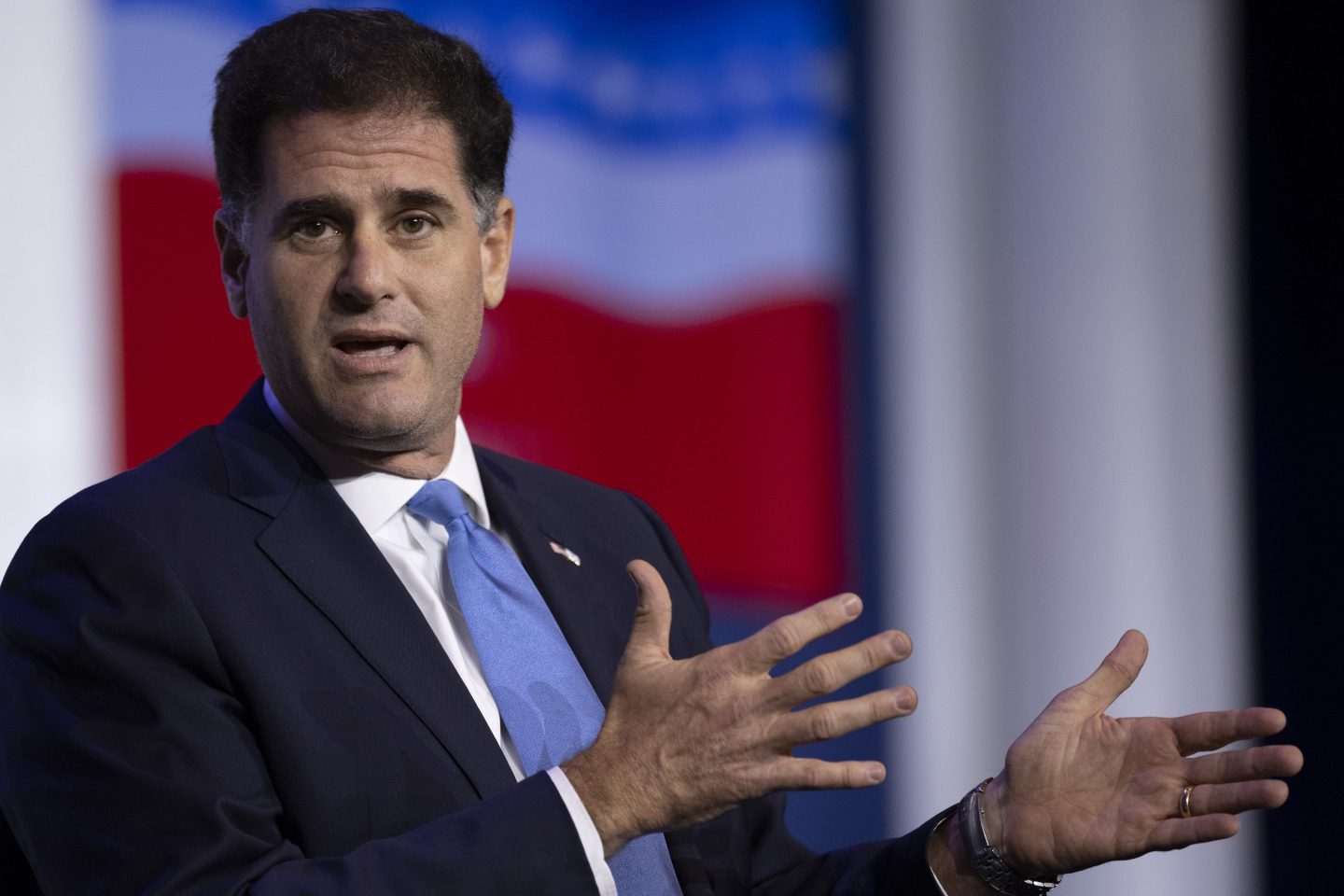 Ron Dermer gesticulates while talking on stage