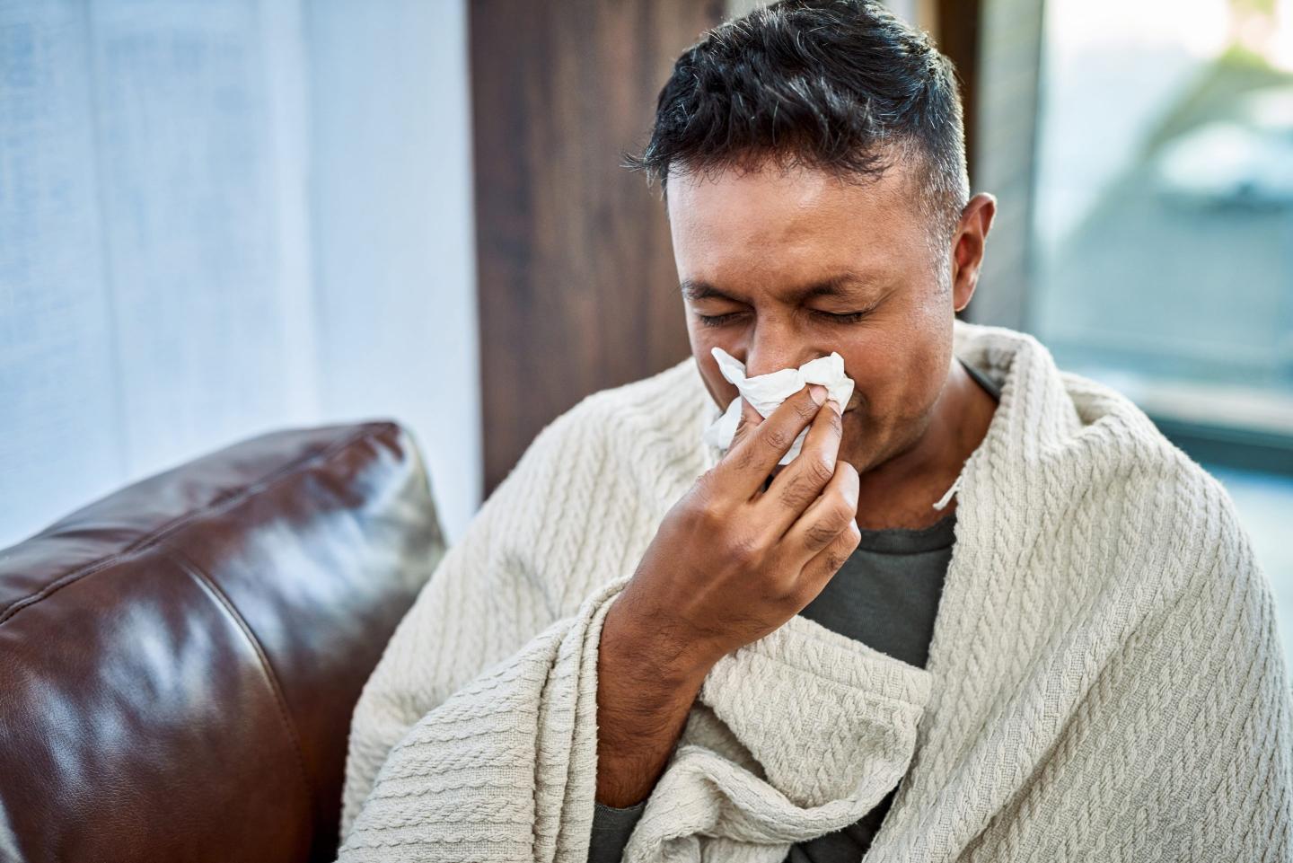 A man blows his nose