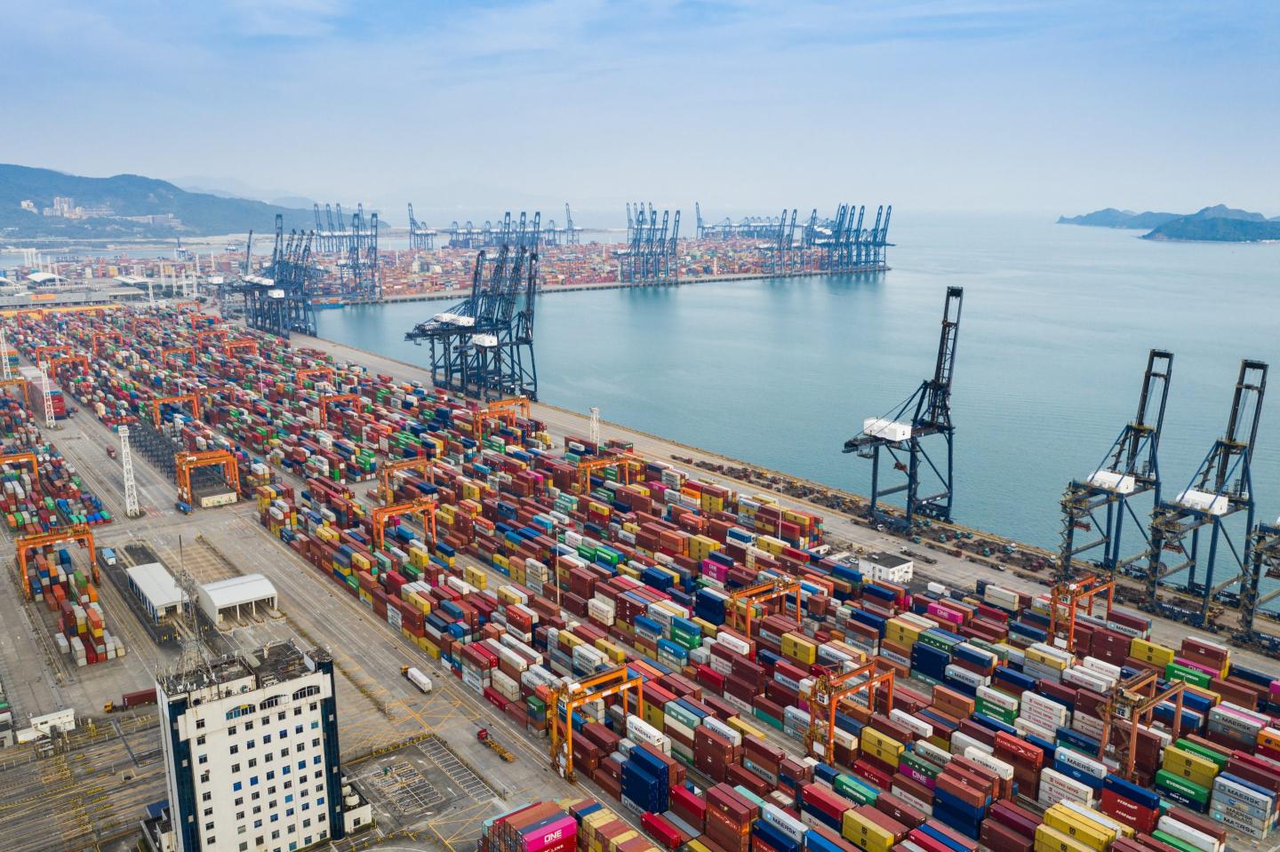 containers lined up at a waterside port