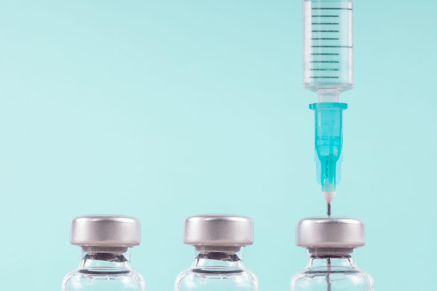 Row of medical vials and syringe