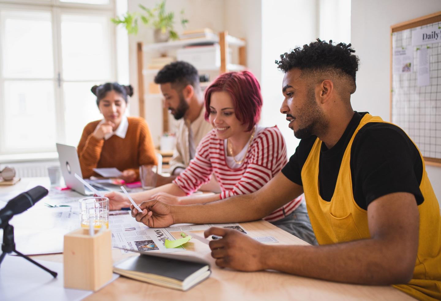 Young Gen Z workers happy at office.