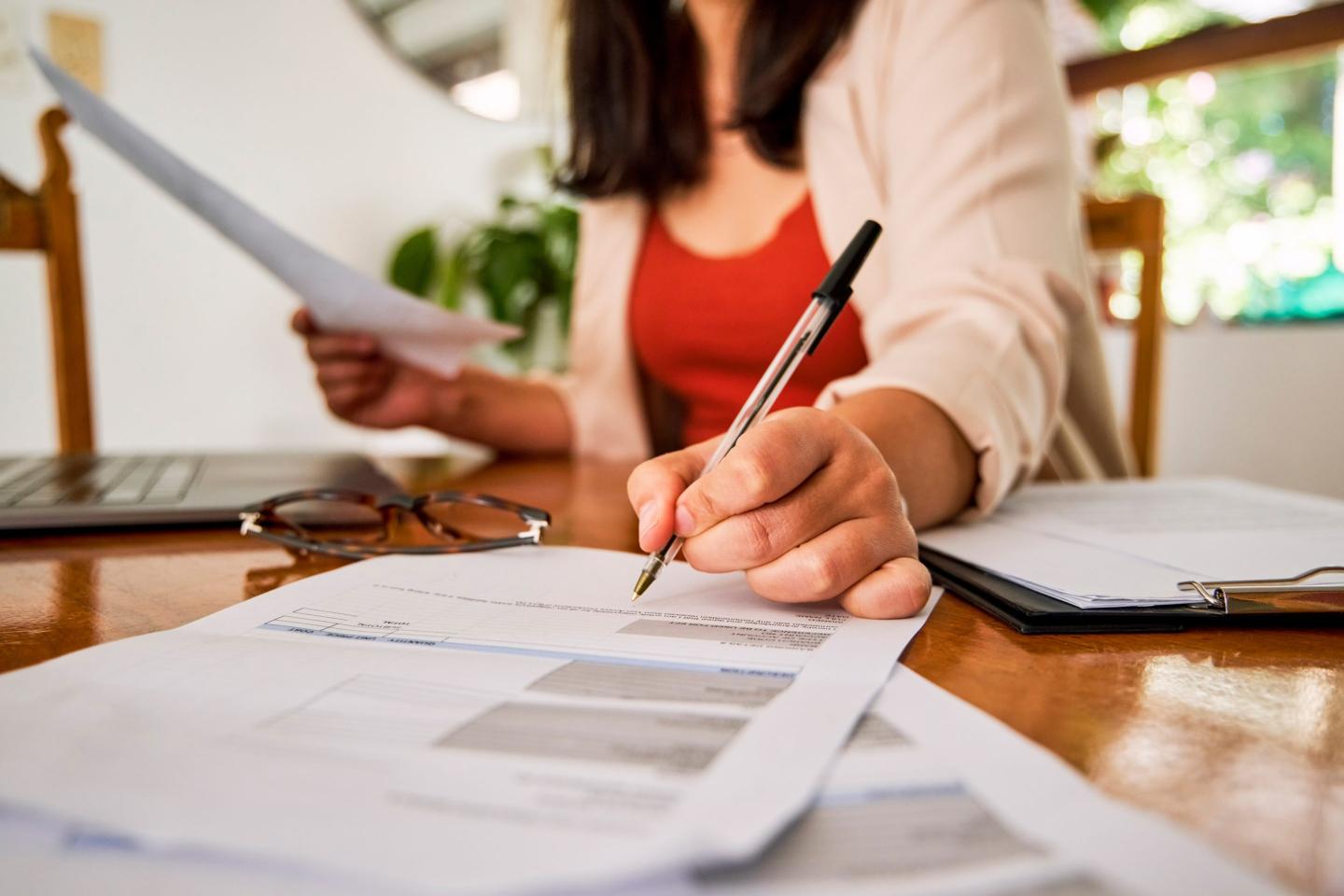 A person filling out forms.