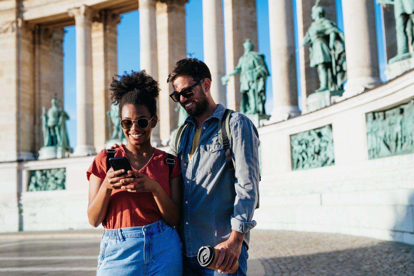 Two people looking at their phone on vacation.