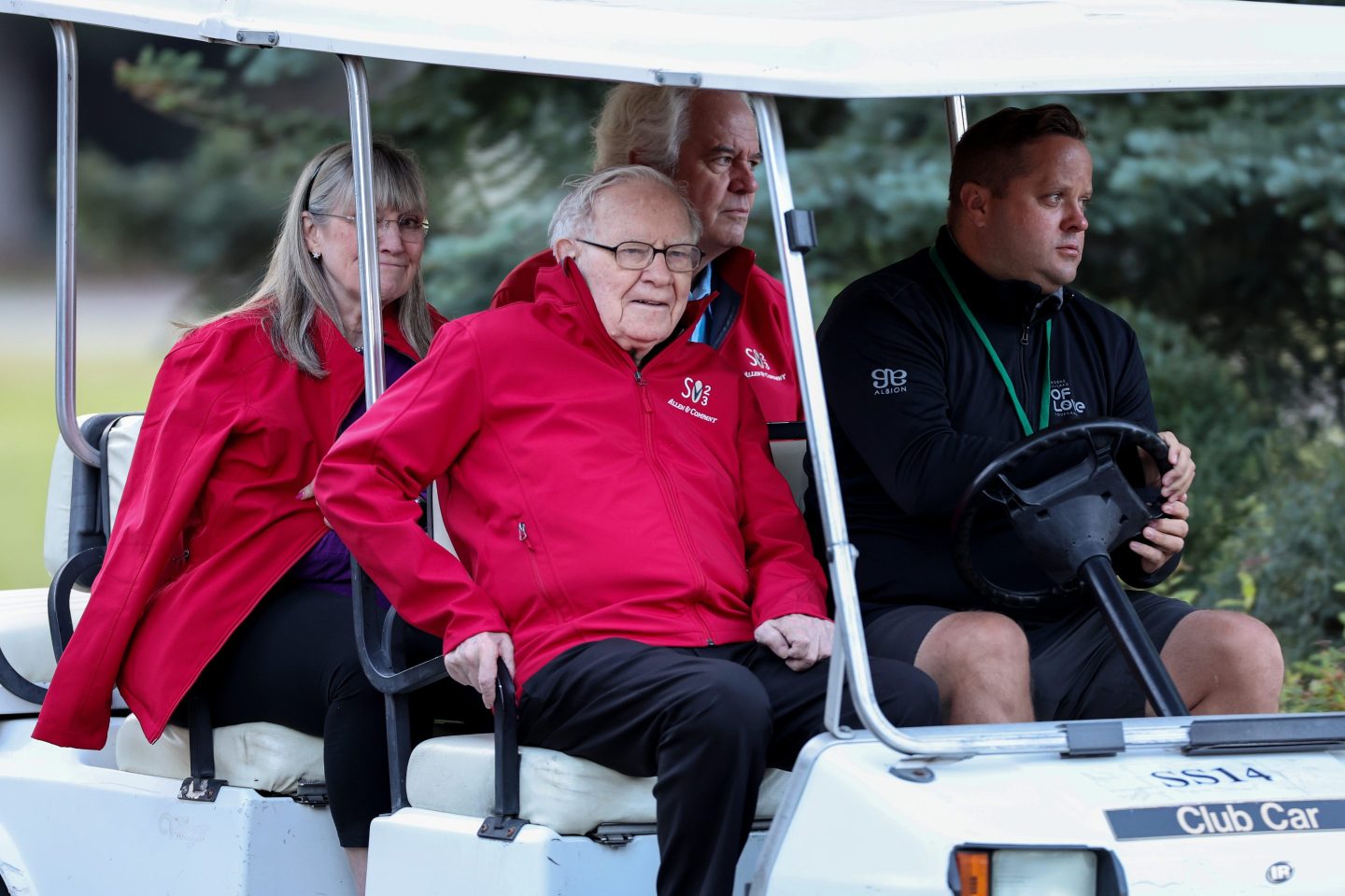 Warren Buffett, Chairman and CEO of Berkshire Hathaway, is driven in a golf cart.