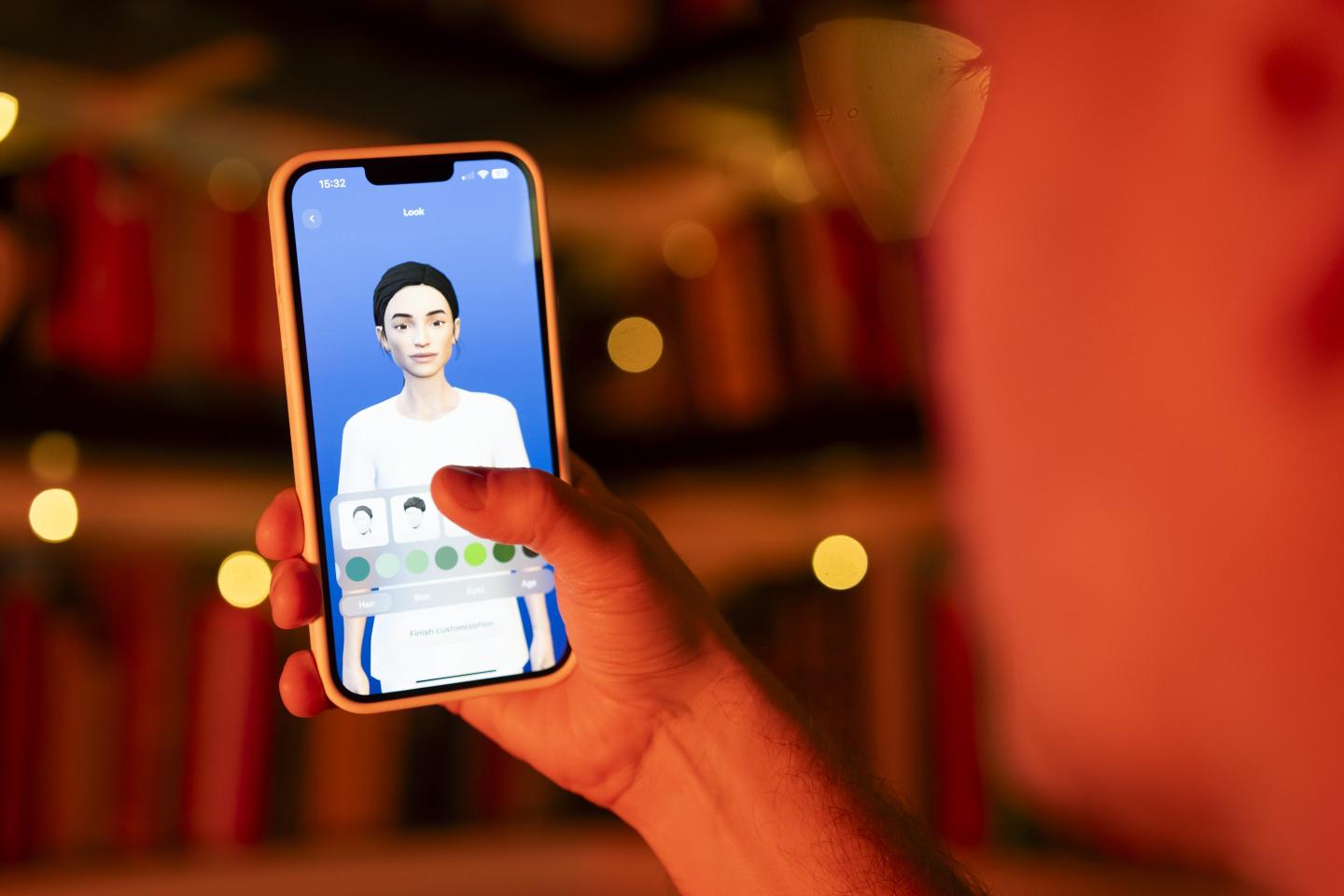 A person holding a smartphone that is displaying a digital avatar of a young woman.