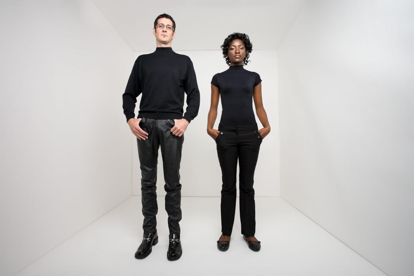 Man and woman standing in a white room