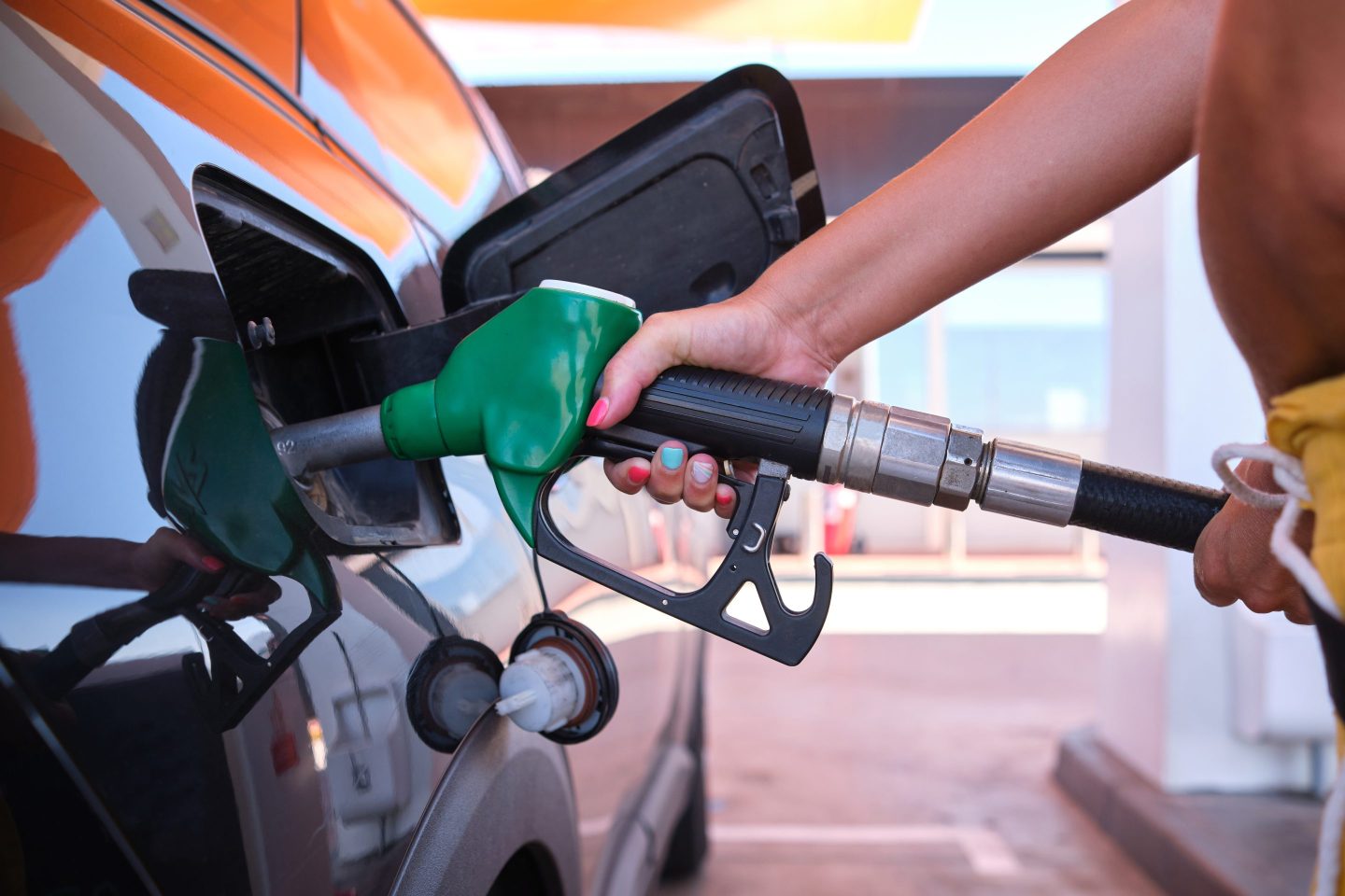 Oil crisis raises price of diesel and gasoil - a woman filling the gas tank