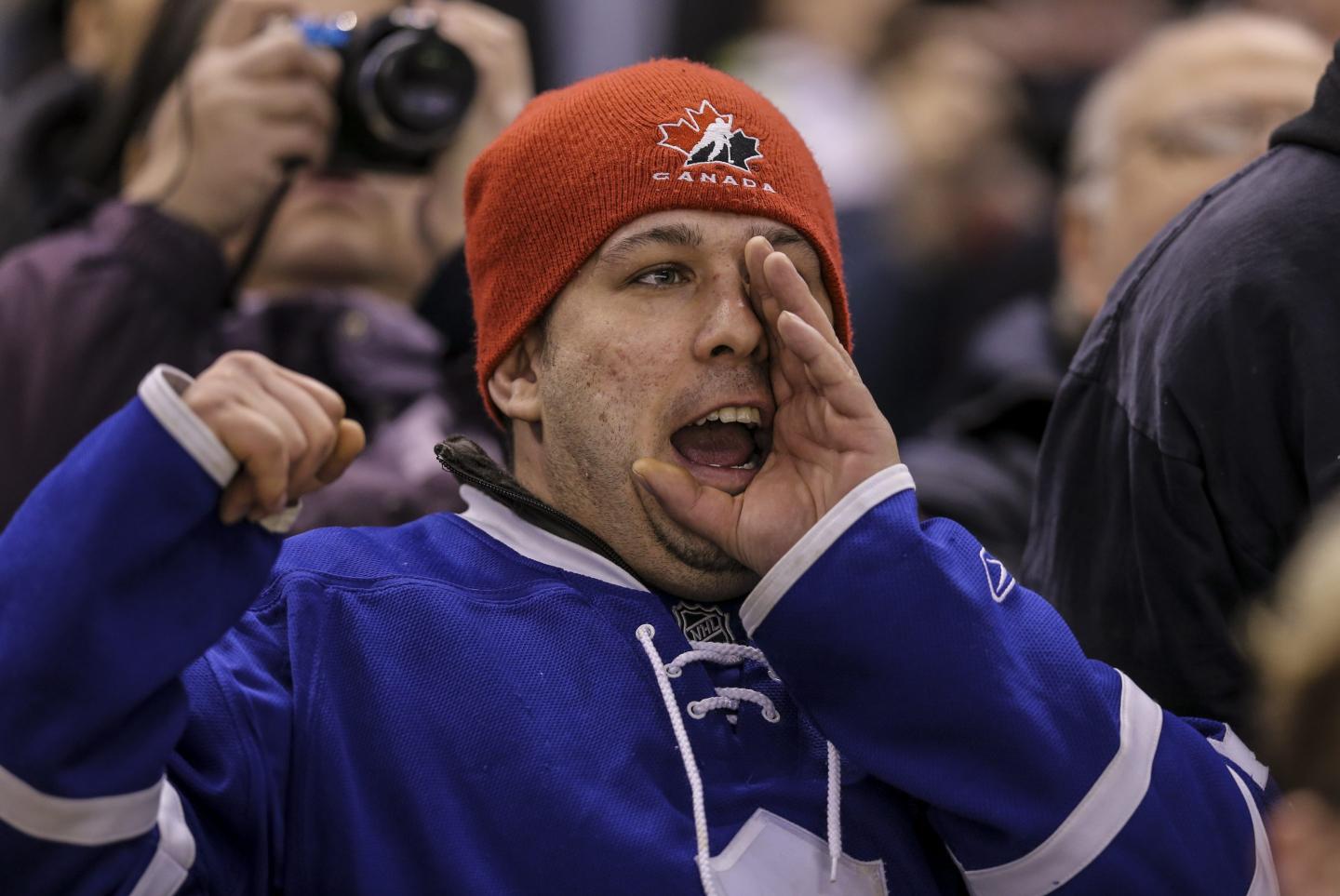 A hockey fan booing from the crowd
