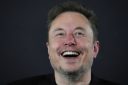 Elon Musk laughs