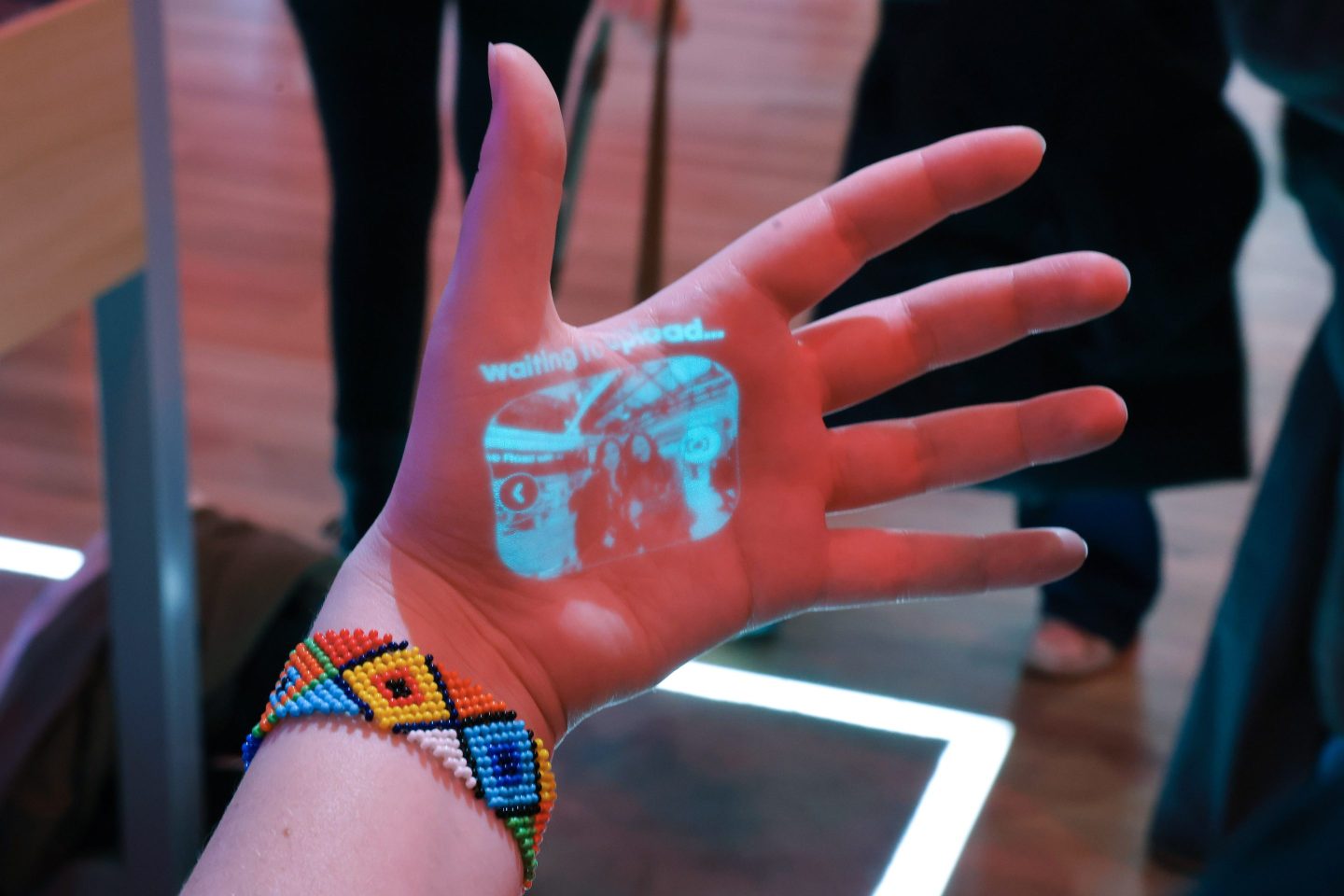 a photograph projected onto a human hand