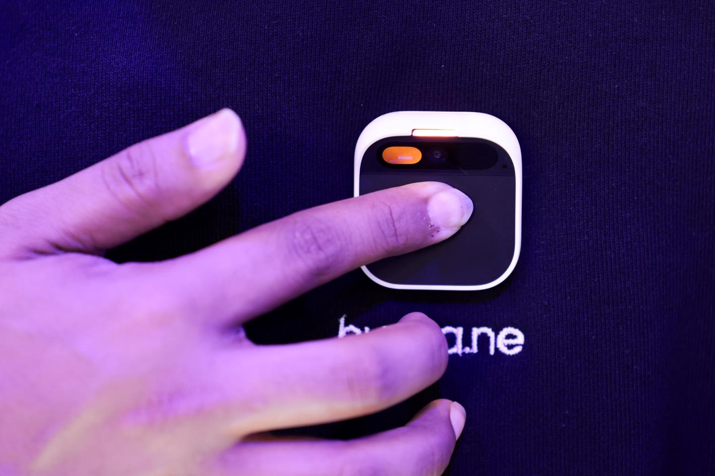 Someone turning on Humane's AI pin