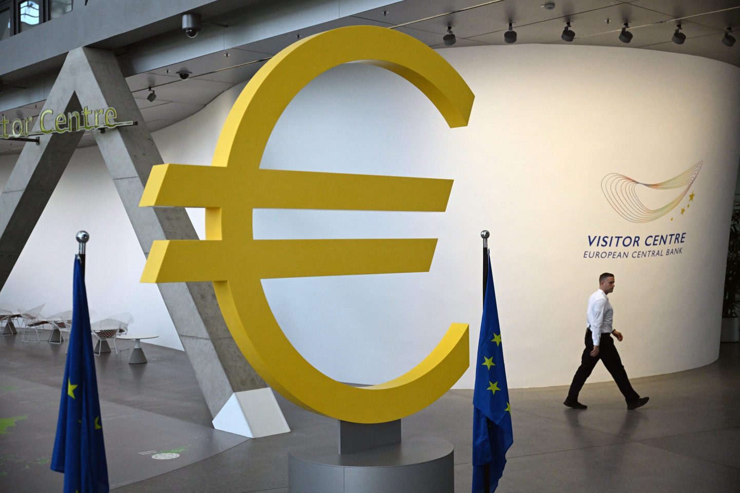 A man walks past a giant Euro logo at the visitor centre of the European Central Bank (ECB) headquarters, ahead of an ECB press conference on the Eurozone's monetary policy, in Frankfurt am Main, western Germany, on July 18, 2024.