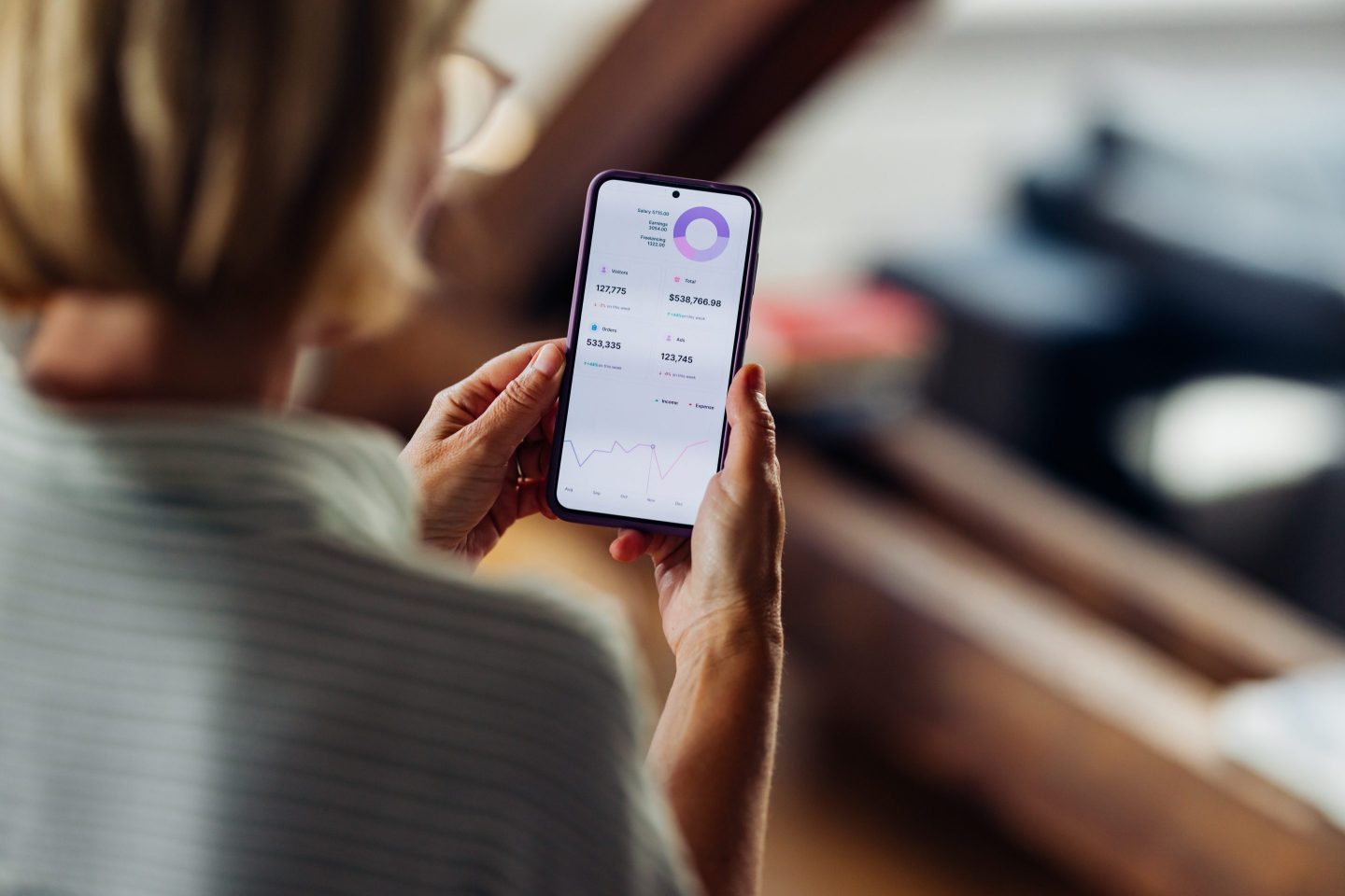 A person looking at a mobile banking app on their phone.