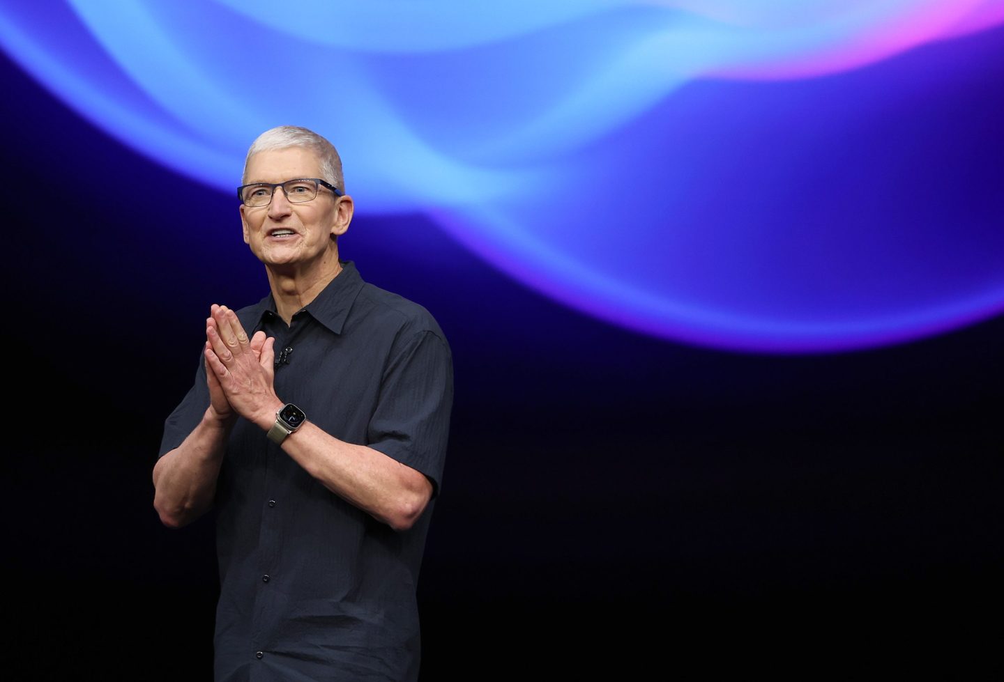 Apple CEO Tim Cook stands on stage and delivers remarks before an Apple event in Cupertino, California.