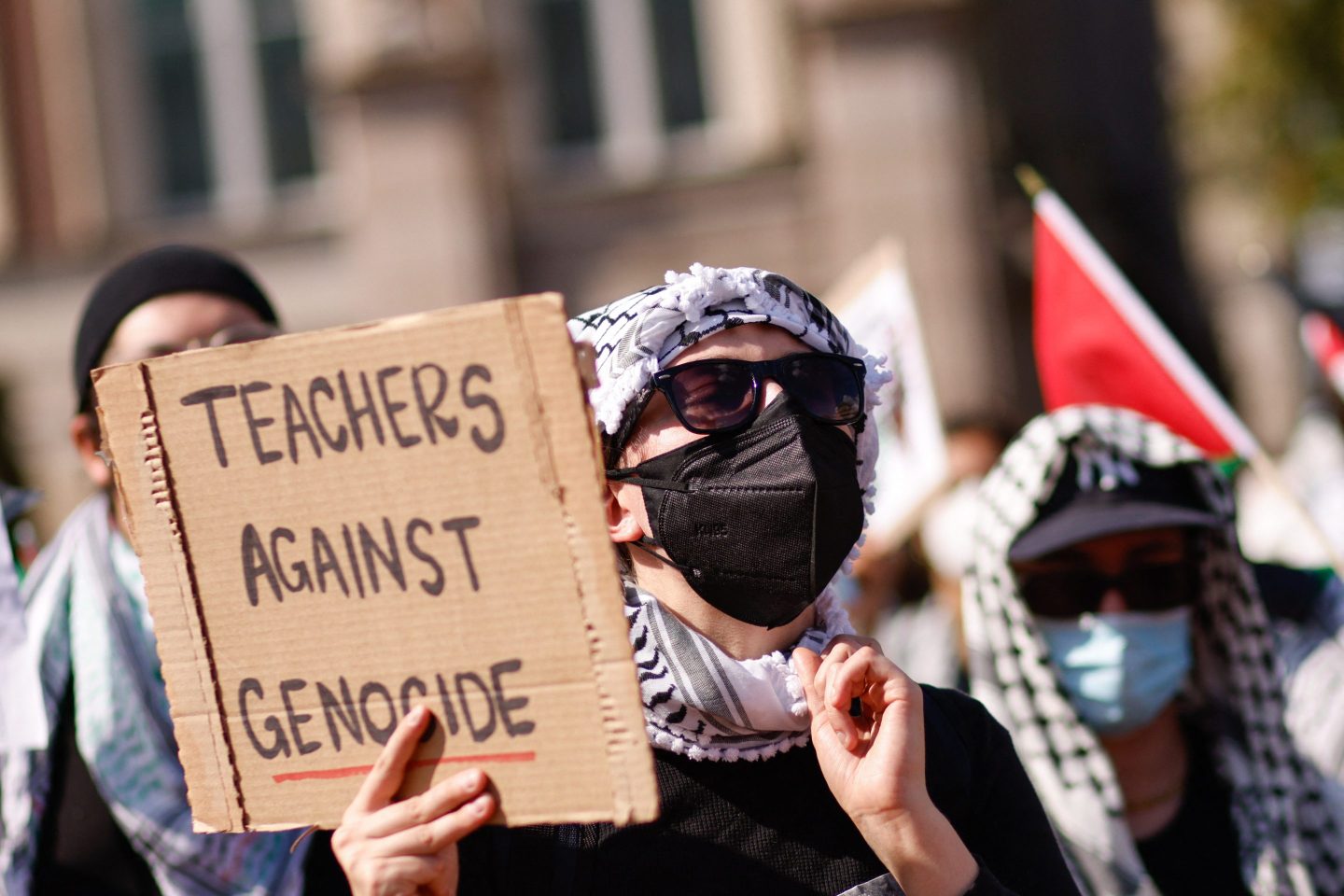 Teachers wear masks while protesting the Israel military action in Gaza