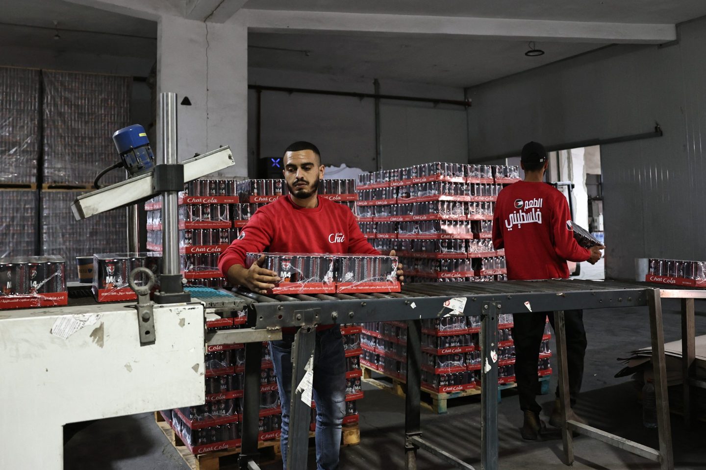 Employees work at the factory of Palestinian carbonated beverages company Chat Cola, in the West Bank city of Salfit, on Nov. 6, 2024.