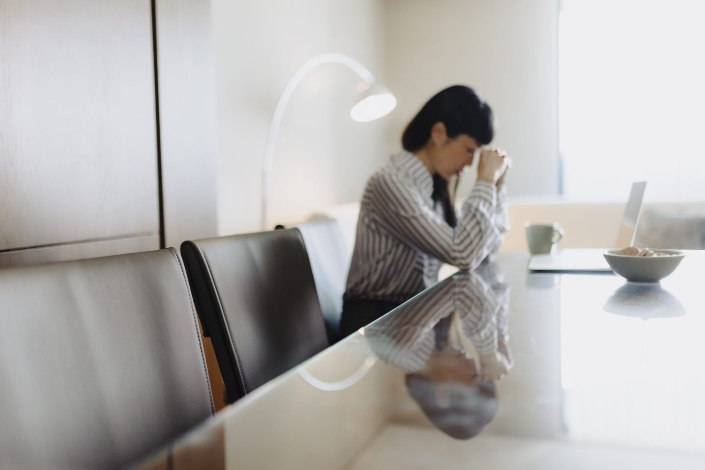 Tired businesswoman working on laptop