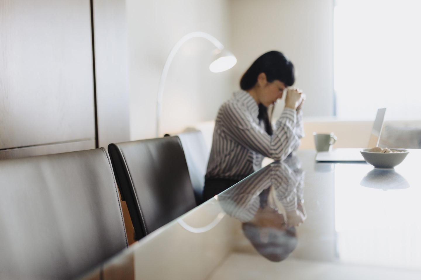 Tired businesswoman working on laptop
