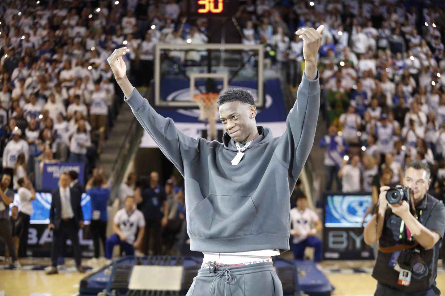 J Dybantsa a member of the Utah Prep high school basketball team waves to the crowd during half time of the Brigham Young Cougars game.