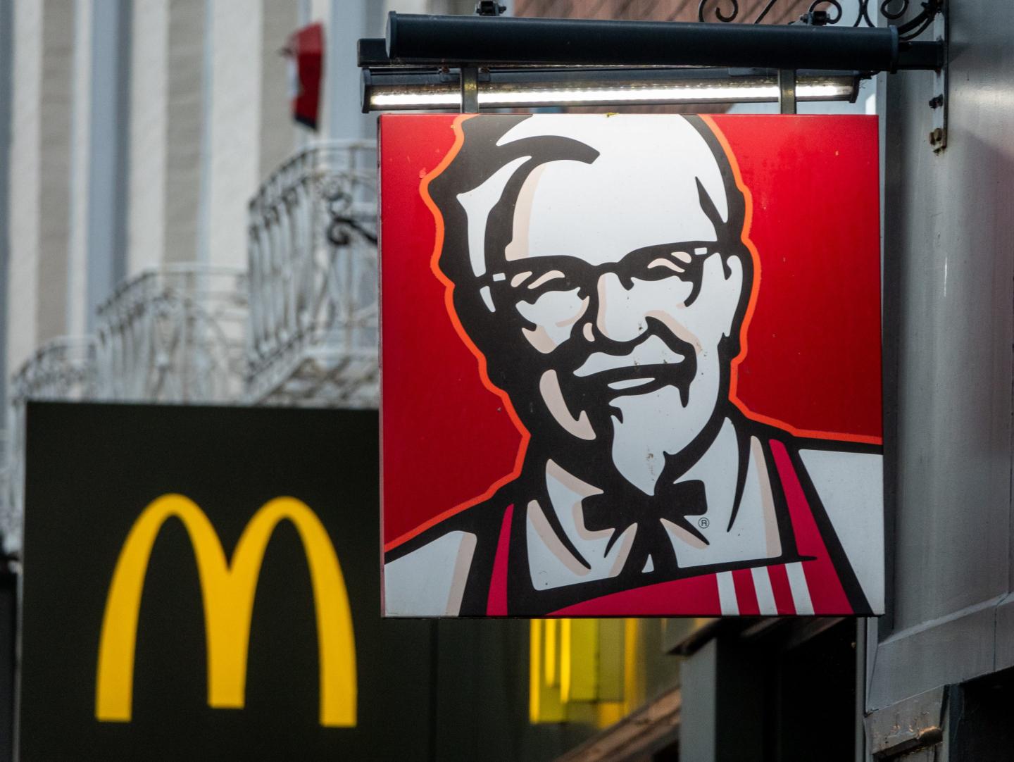 Lights illuminate the logo of Colonel Sanders, founder of the Kentucky Fried Chicken fast food restaurant KFC outside a branch which is next door to McDonald's restaurant, on December 24, 2024 in Taunton, England.
