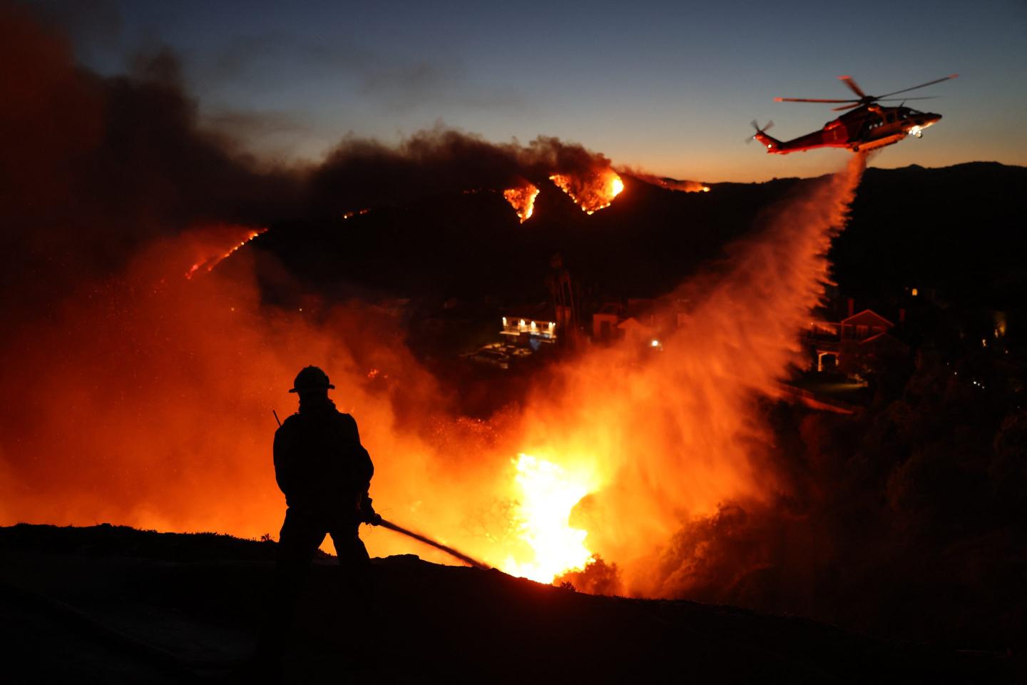 Firefighter and helicopter fight LA wildfire