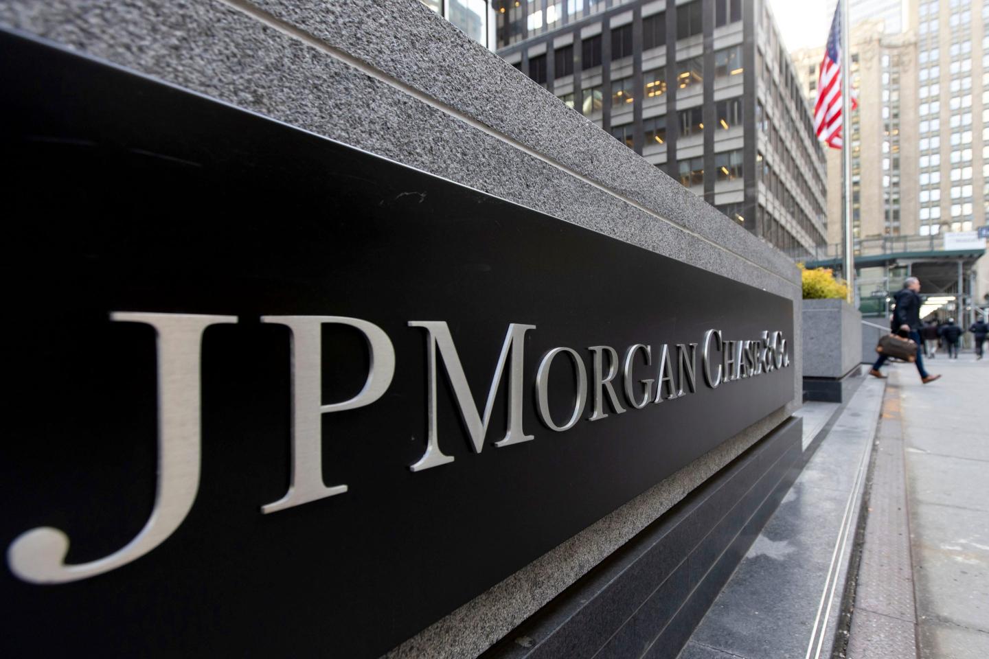 JP Morgan Chase sign outside of a New York City office building with an American Flag in the background