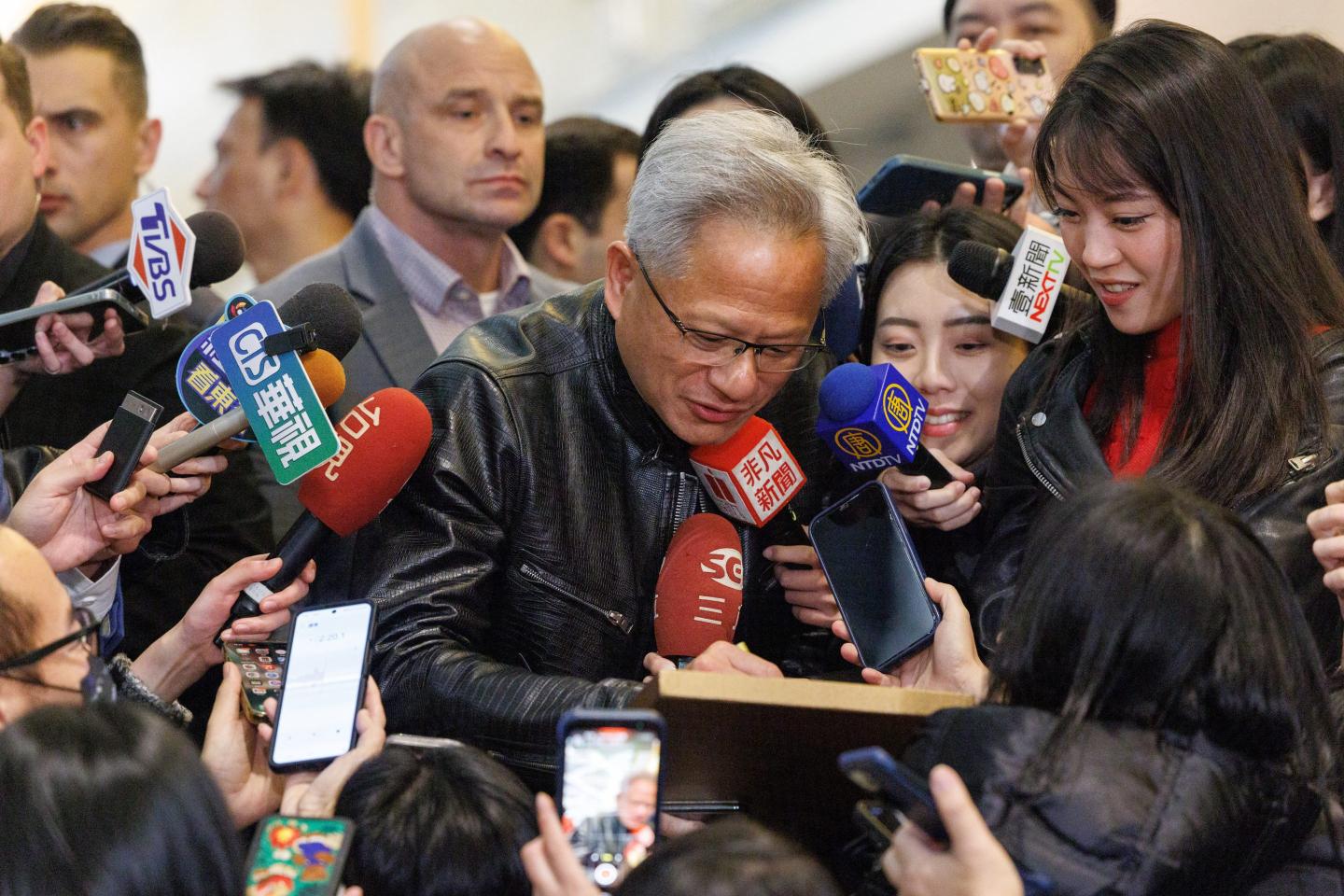 Nvidia CEO Jensen Huang is swarmed by reporters