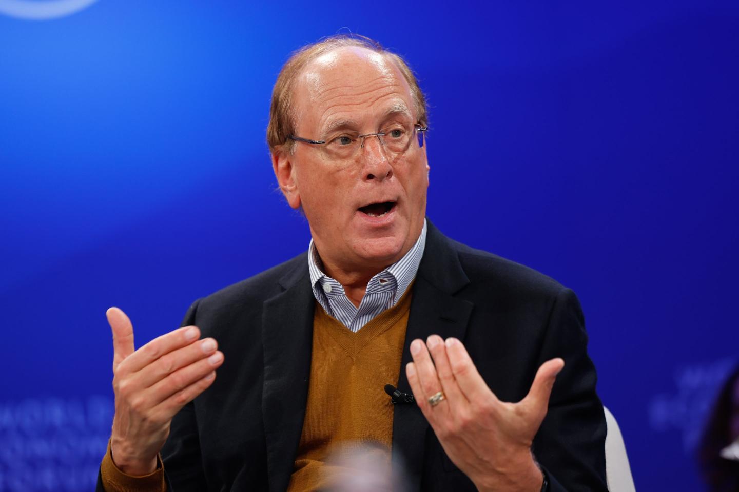 Larry Fink speaking on stage