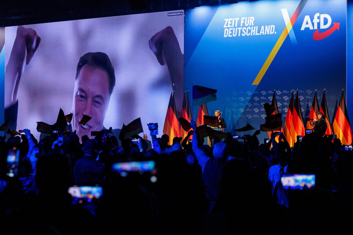 US tech billionaire and businessman Elon Musk is seen on a large screen as Alice Weidel, co-leader of Germany's far-right Alternative for Germany (AfD) party, addresses an election campaign rally in Halle, eastern Germany on January 25.