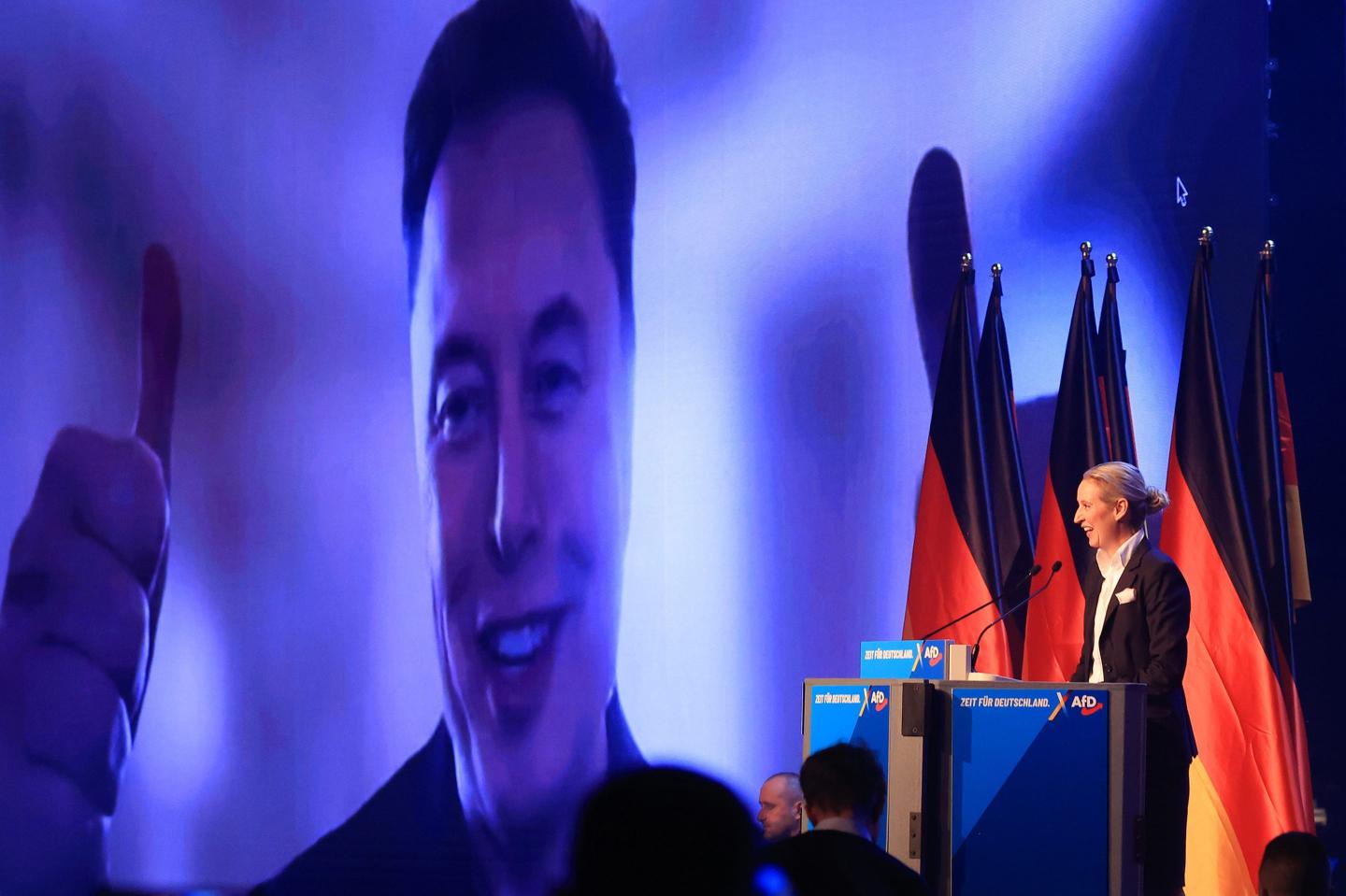 Elon Musk, chief executive officer of Tesla Inc., speaks virtually alongside Alice Weidel, co-leader of Alternative for Germany (AfD), during a the party's general election campaign launch in Halle, Germany, on Saturday, Jan. 25, 2025
