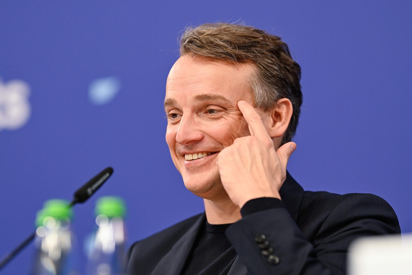 SAP CEO Christian Klein smiles in front of the microphone