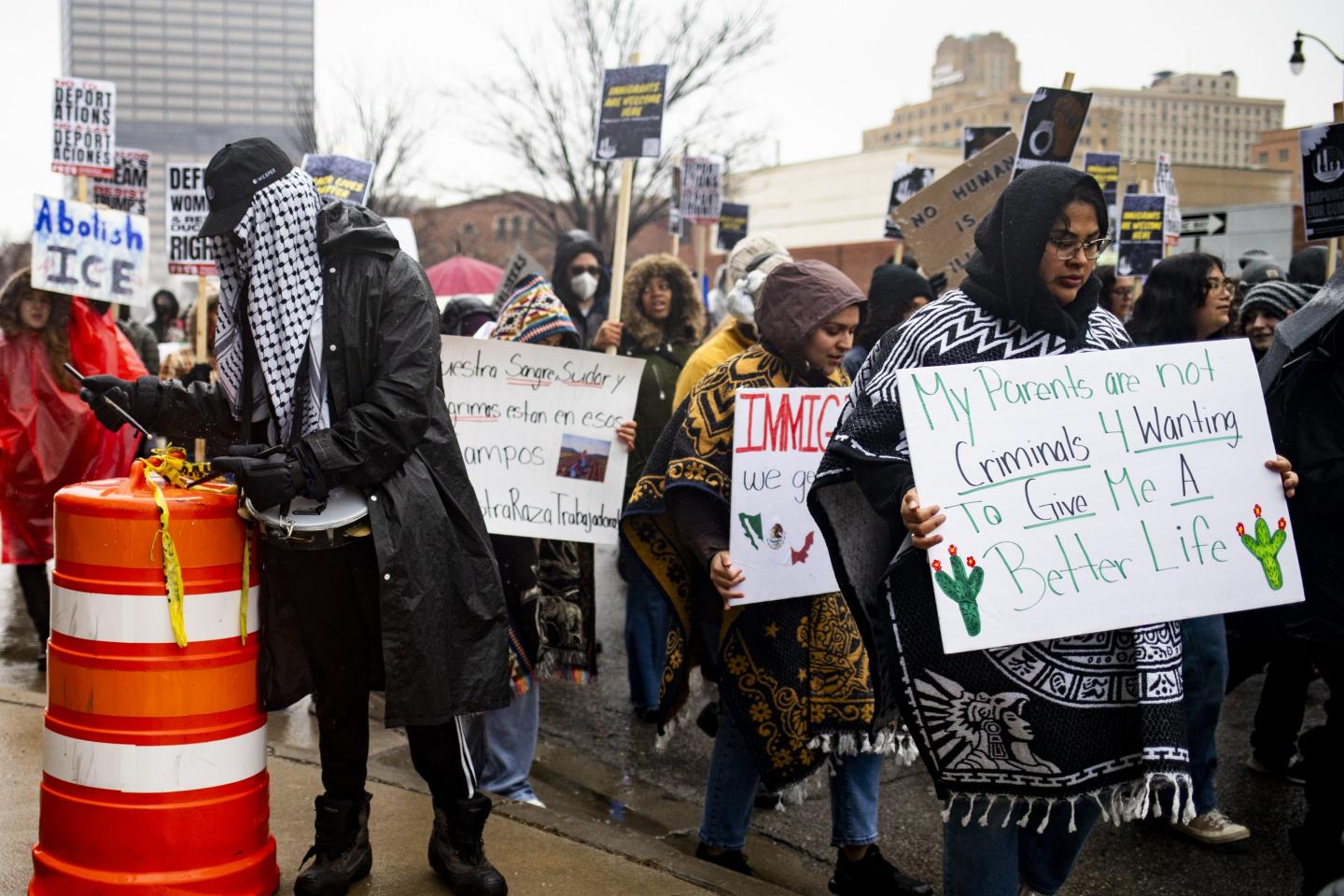 People march with signs outside the U.S. Immigration and Customs Enforcement headquarters
