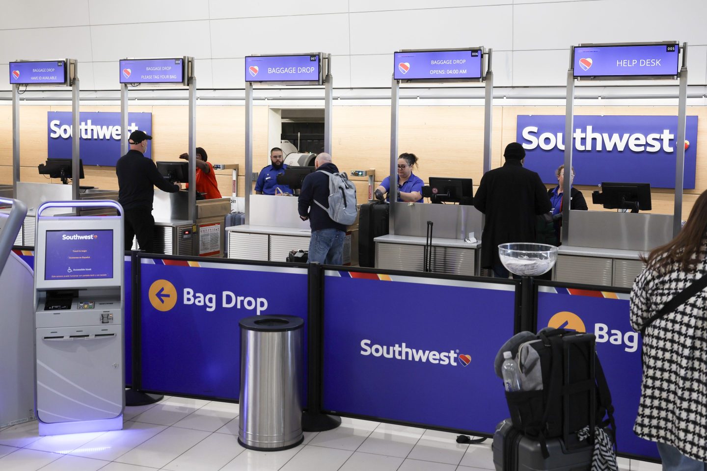 Customers at Southwest Airlines Baggage Drop station.