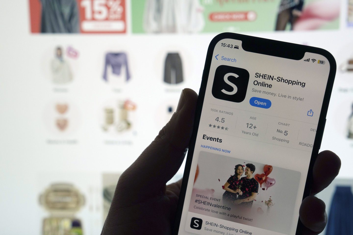 person holding shein app