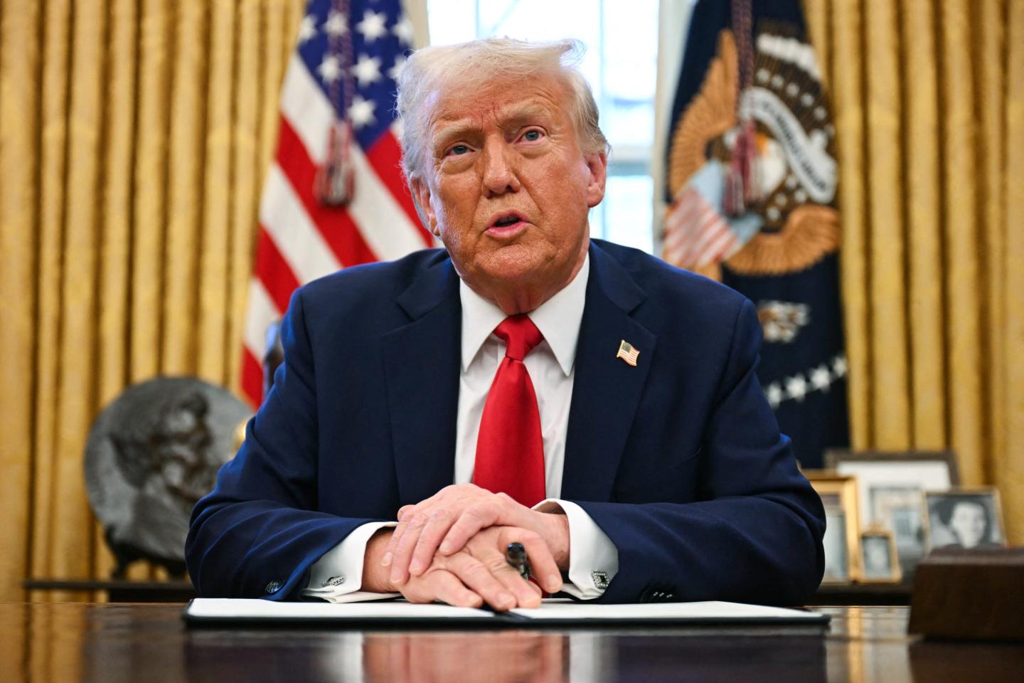 Donald Trump speaks to the press as he signs an executive order