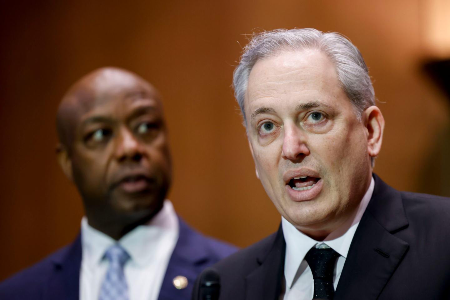 David Sacks, AI and crypto czar with the Trump admin, speaks during a news conference on Feb. 4, with GOP senator Tim Scott behind him.
