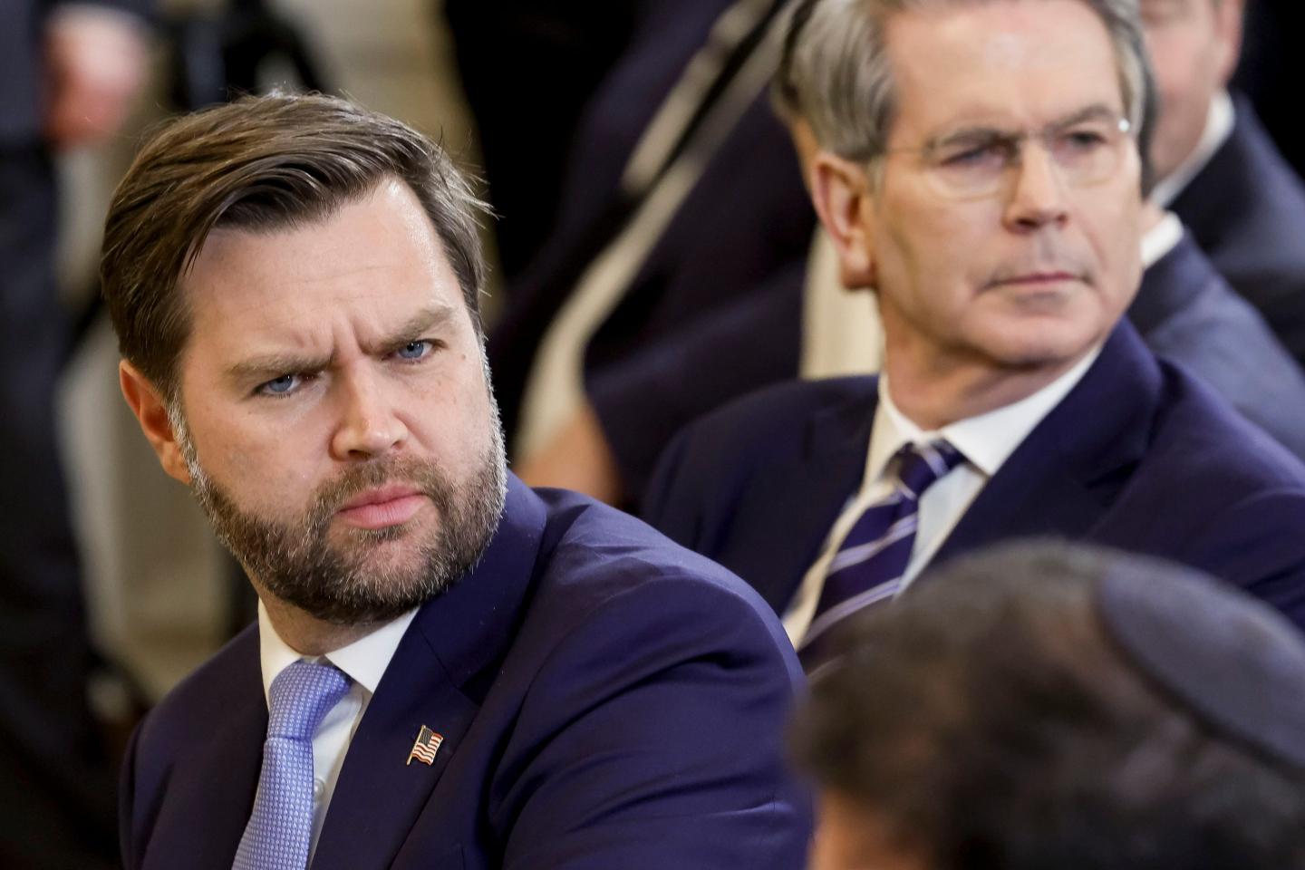 JD Vance turns his head during a news conference