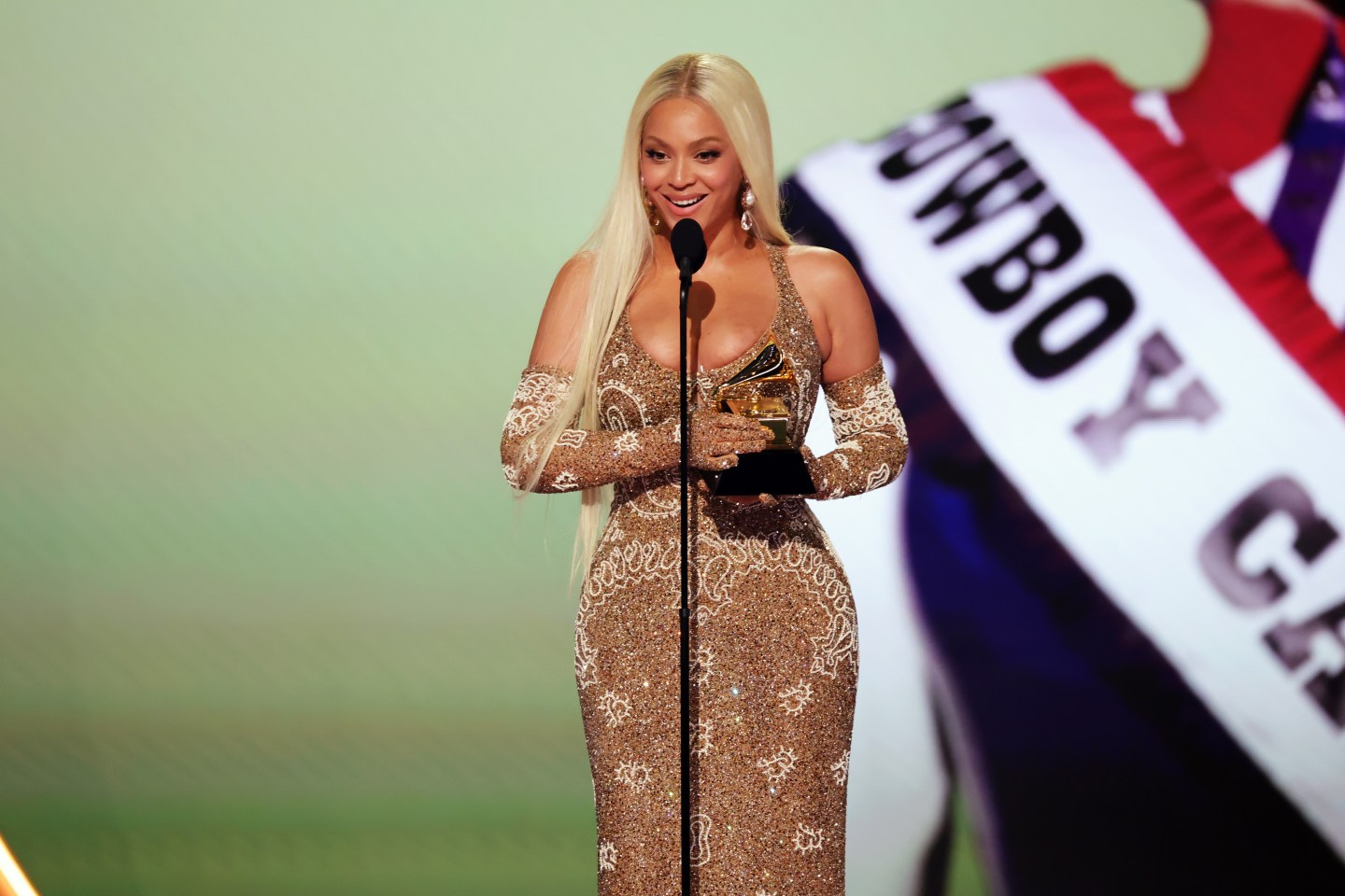 Beyoncé, wearing a blonde wig and formal dress, onstage at the GRAMMY Awards
