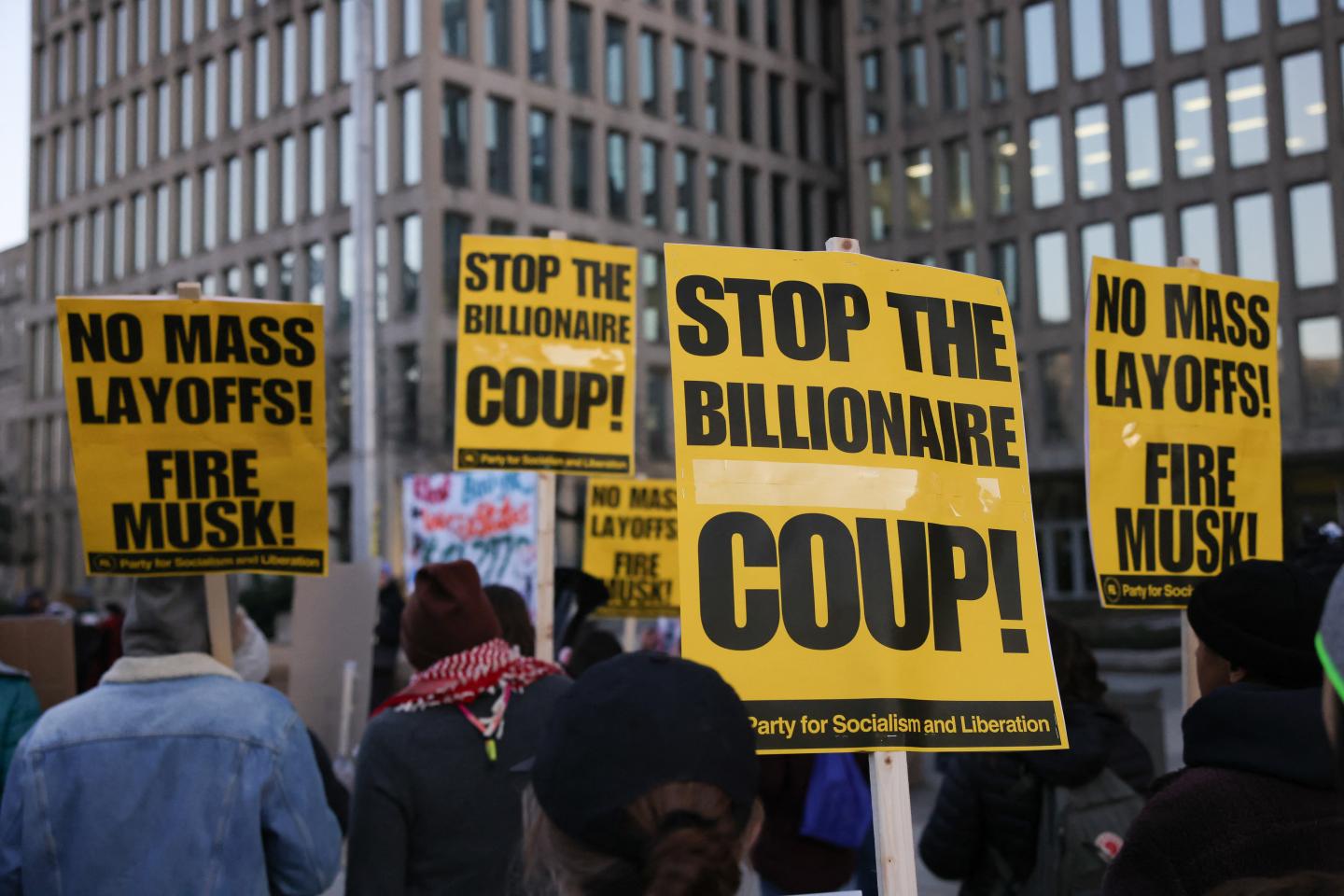 Protesters hold signs saying Stop the Billionaire Coup outside the Office of Personnel Management in Washington DC