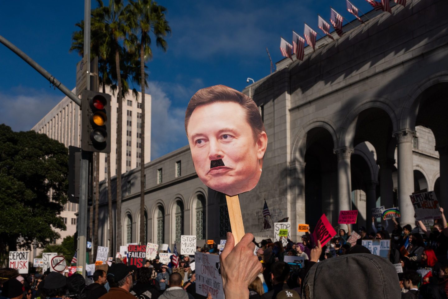 A protester holds a sign depicting Elon Musk during a demonstration outside of Los Angeles City Hall to demonstrate for immigration rights on February 5, 2025 in Los Angeles.