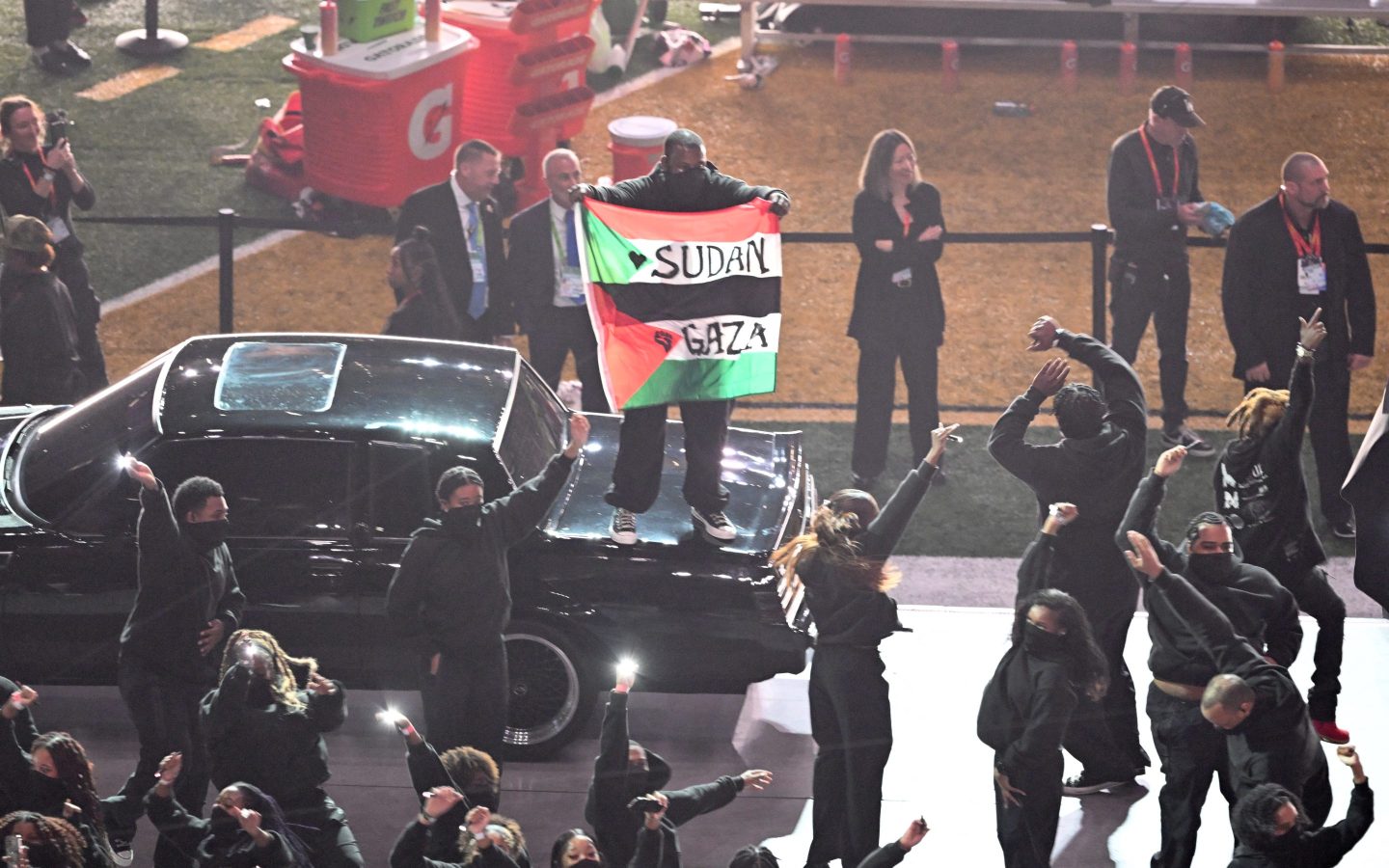 A performer for Kendrick Lamar surprises the crowd by protesting with a Sudan-Gaza flag